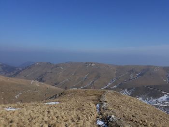 Scenic view of mountains against clear blue sky