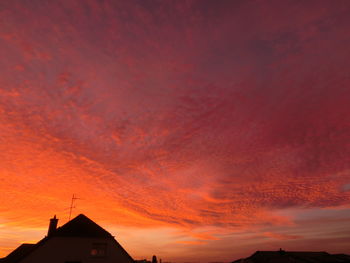 Low angle view of silhouette buildings against sky during sunset