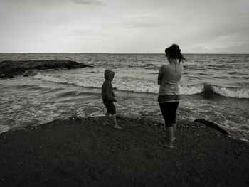 Rear view of man standing on beach