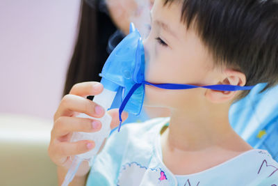 Close-up of boy wearing nebulizer mask