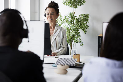 Smiling mature woman working in call center