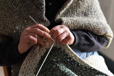 Midsection of woman knitting