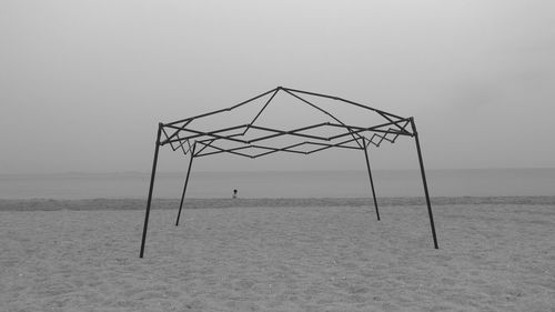 Structure on beach against sky