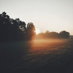 Scenic view of sunrise over lake against sky during sunset