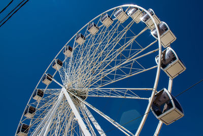 Low angle view of metallic structure against clear blue sky