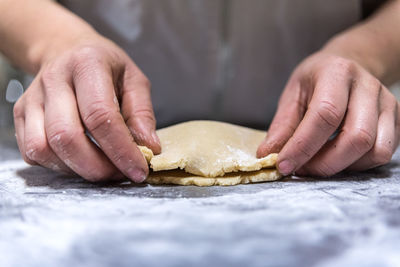 Close-up of person preparing food on table
