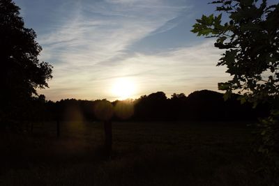 Scenic view of field against sky during sunset