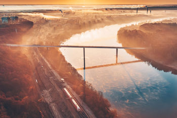 High angle view of road by sea against sky during sunset