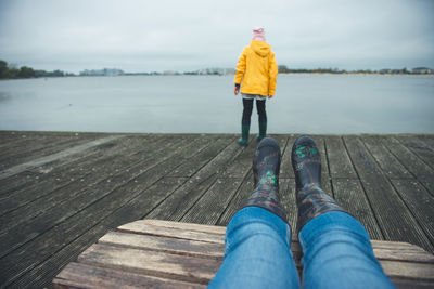 Low section of man standing on pier