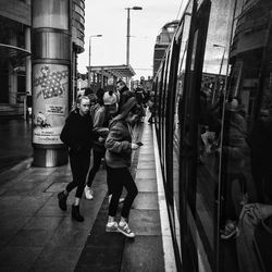 People walking on road in city