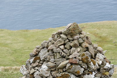 Stack of stones against calm rippled water