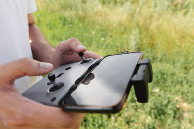 Midsection of man using mobile phone