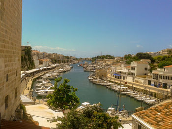 High angle view of river amidst buildings against sky