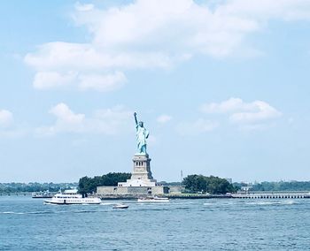 Statue of liberty against cloudy sky