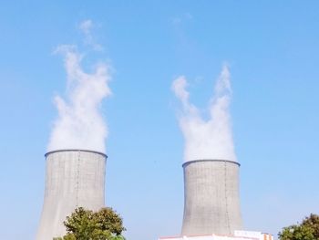 Low angle view of smoke stack against sky