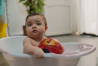 Close-up of cute baby girl in bathtub