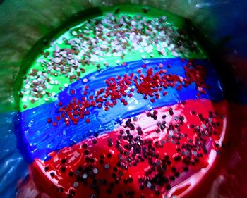 Close-up of multi colored glass on table