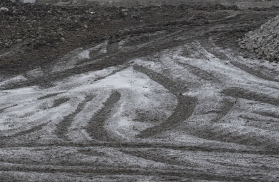 High angle view of tire tracks on snow covered land