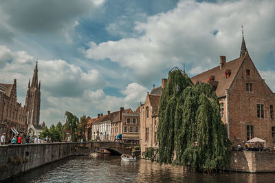 River amidst buildings against sky in city