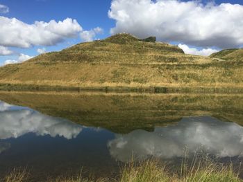 Scenic view of lake and mountains against sky