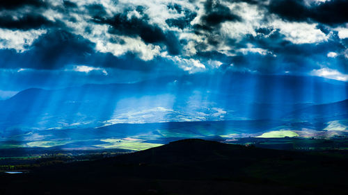 Scenic view of dramatic sky over landscape
