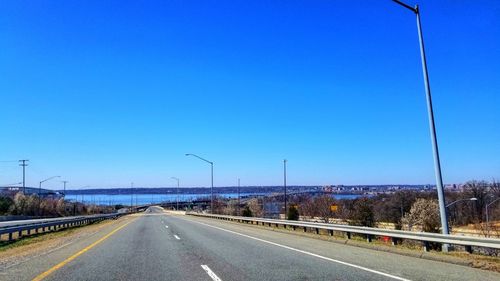 Highway against clear blue sky