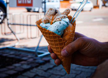 Close-up of hand holding ice cream cone