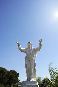 Low angle view of statue against blue sky