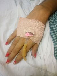 High angle view of hand with iv drip in hospital