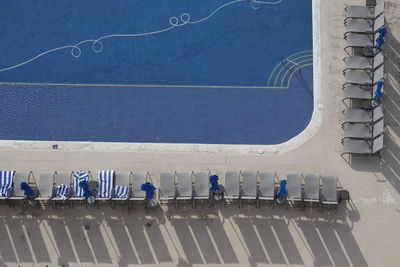 High angle view of people by sea against blue sky