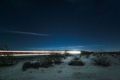 Light trails on country road at night