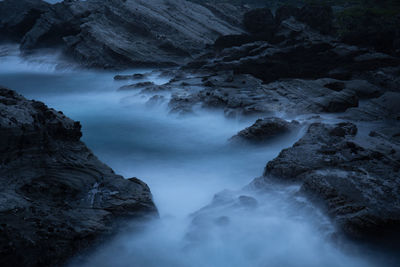 Long exposure of river amidst rocks