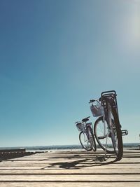 Bicycles against clear blue sky