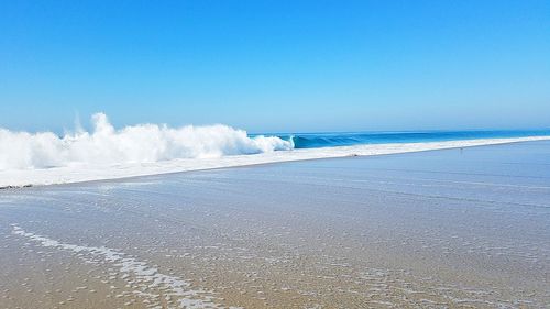 Scenic view of sea against clear blue sky