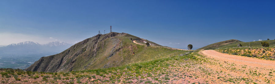 Scenic view of mountains against clear blue sky