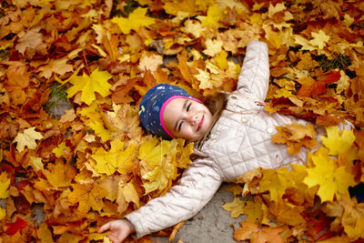 Portrait of a boy lying down leaves