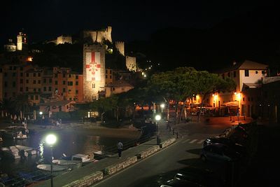 Illuminated city against sky at night