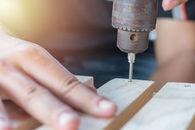 Midsection of person working on wood