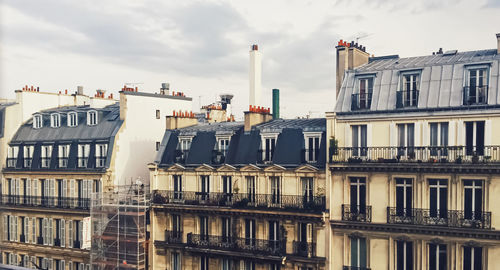 Low angle view of buildings against sky in city