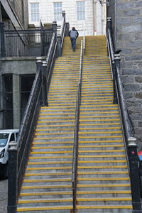 Rear view of person on staircase in city