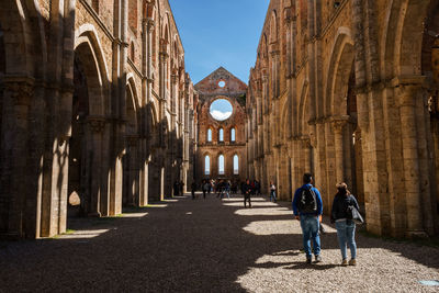 People walking in historic building