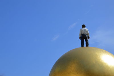 Low angle view of statue against blue sky