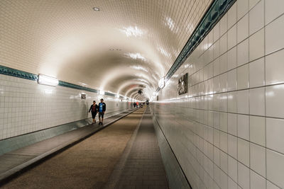 People in illuminated tunnel