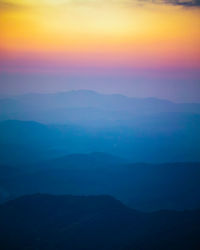 Scenic view of silhouette mountains against sky during sunset