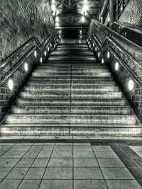 Staircase in illuminated tunnel