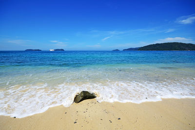 Scenic view of sea against blue sky