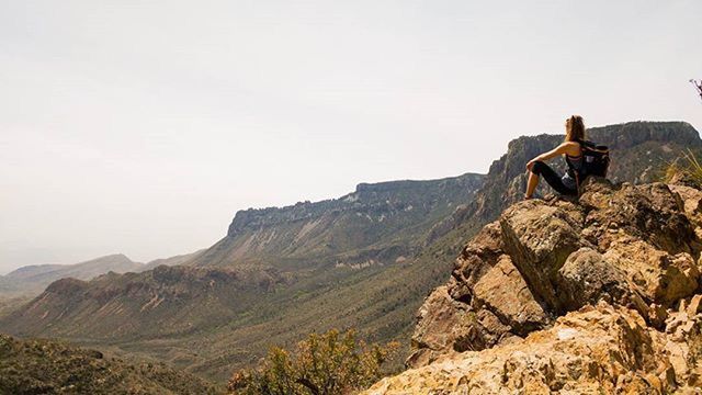 lifestyles, leisure activity, men, mountain, full length, rear view, rock - object, hiking, casual clothing, standing, landscape, adventure, person, tranquil scene, scenics, sky, clear sky, nature