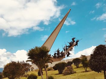 Low angle view of statue in park against sky