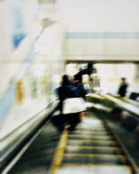 Blurred motion of people walking on road