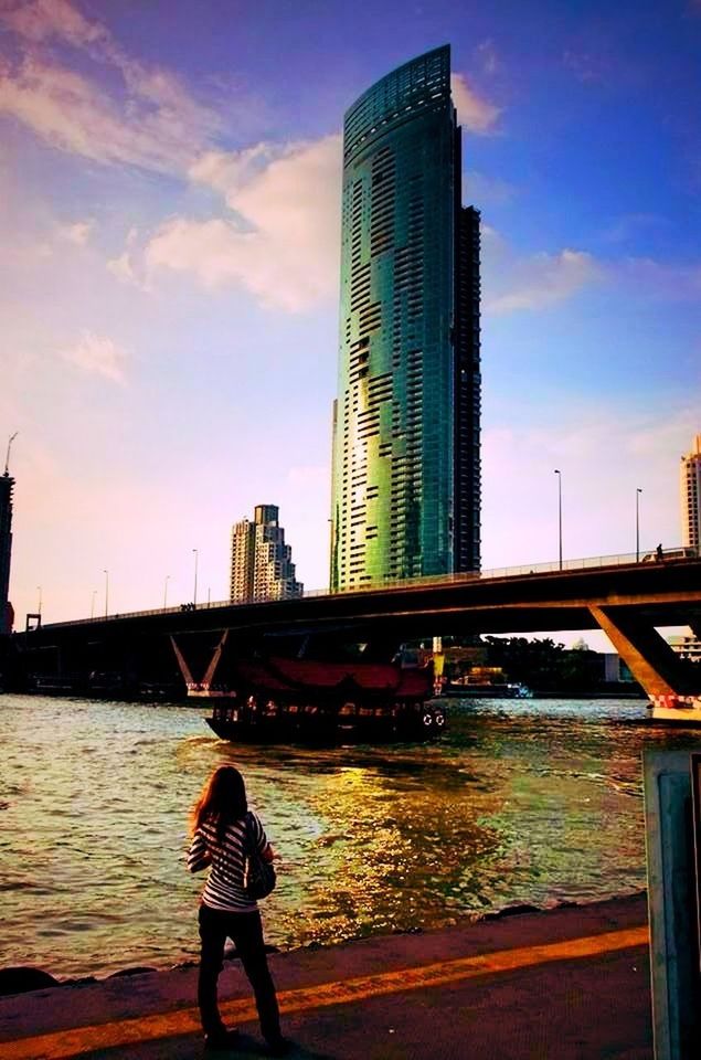 architecture, built structure, building exterior, city, water, bridge - man made structure, sky, connection, skyscraper, river, lifestyles, modern, tower, city life, tall - high, capital cities, men, leisure activity